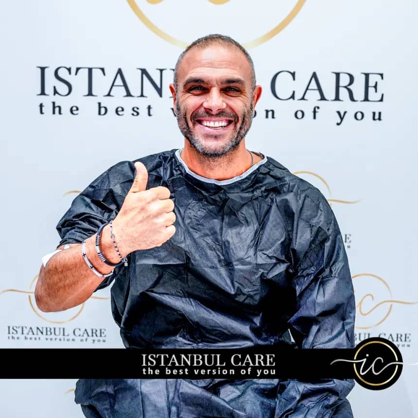 Patient in a surgical gown giving a thumbs up at Istanbul Care